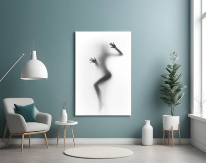 Woman Shadow Glass Wall Art displayed on a teal wall above a white armchair in a minimalist interior setting.