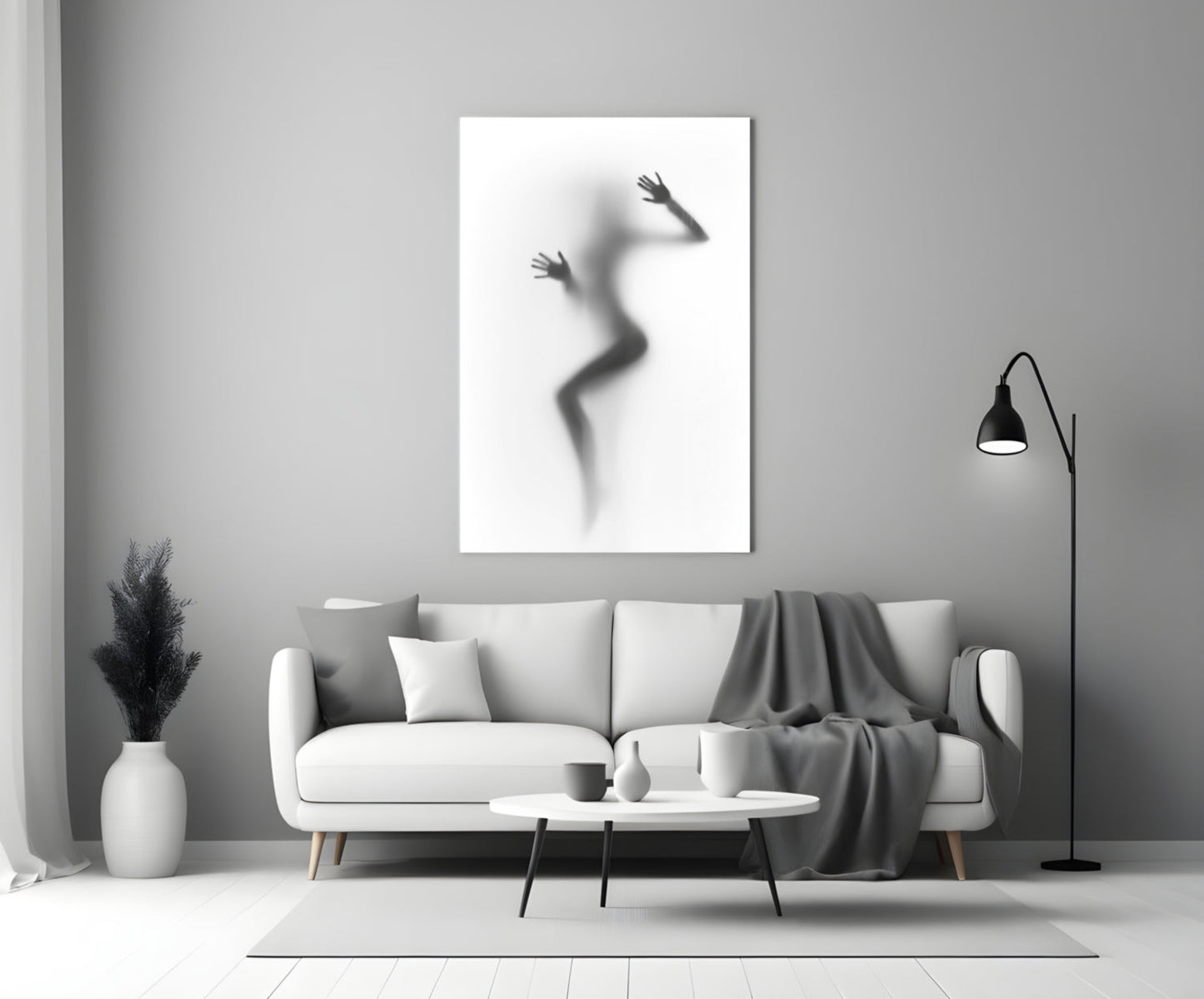 Woman Shadow Glass Wall Art displayed above a white sofa in a minimalist living room setting.