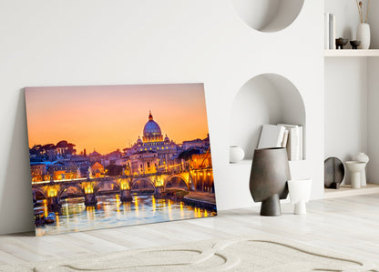 St. Peter's Basilica glass wall art leaning against white wall in minimalist room setting with decorative objects.