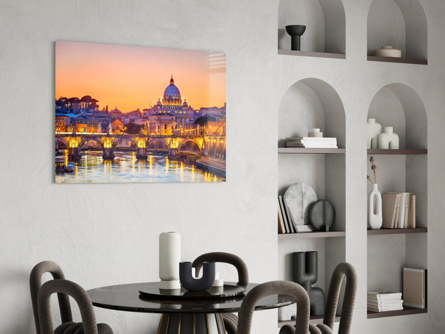 Glass wall art of St. Peter's Basilica at sunset displayed above a dining table in a modern interior.