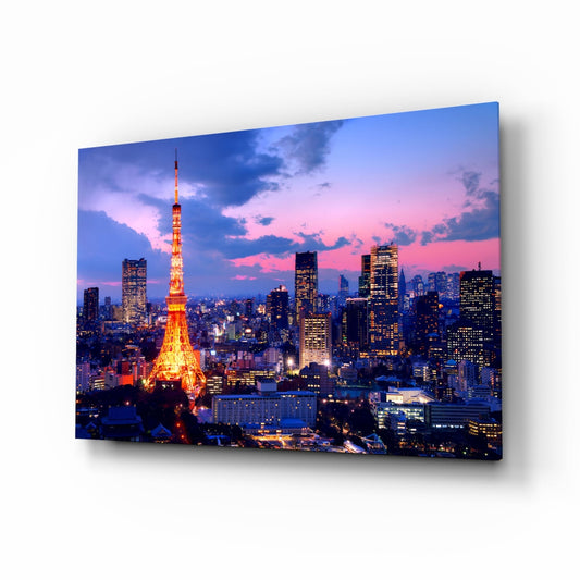 Tokyo Tower illuminated in red and gold at twilight with surrounding city buildings and purple-blue sky, displayed as a glass wall art panel.