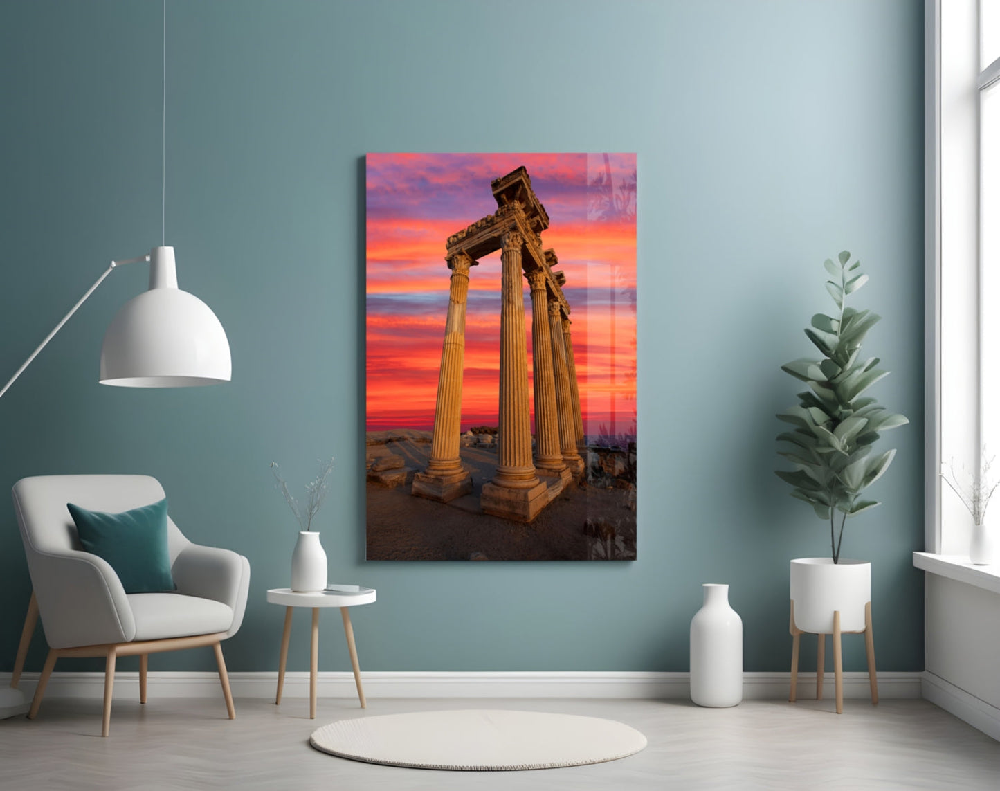 Temple of Apollo glass wall art displayed in a room setting showing ancient columns against a vibrant orange and pink sunset sky.