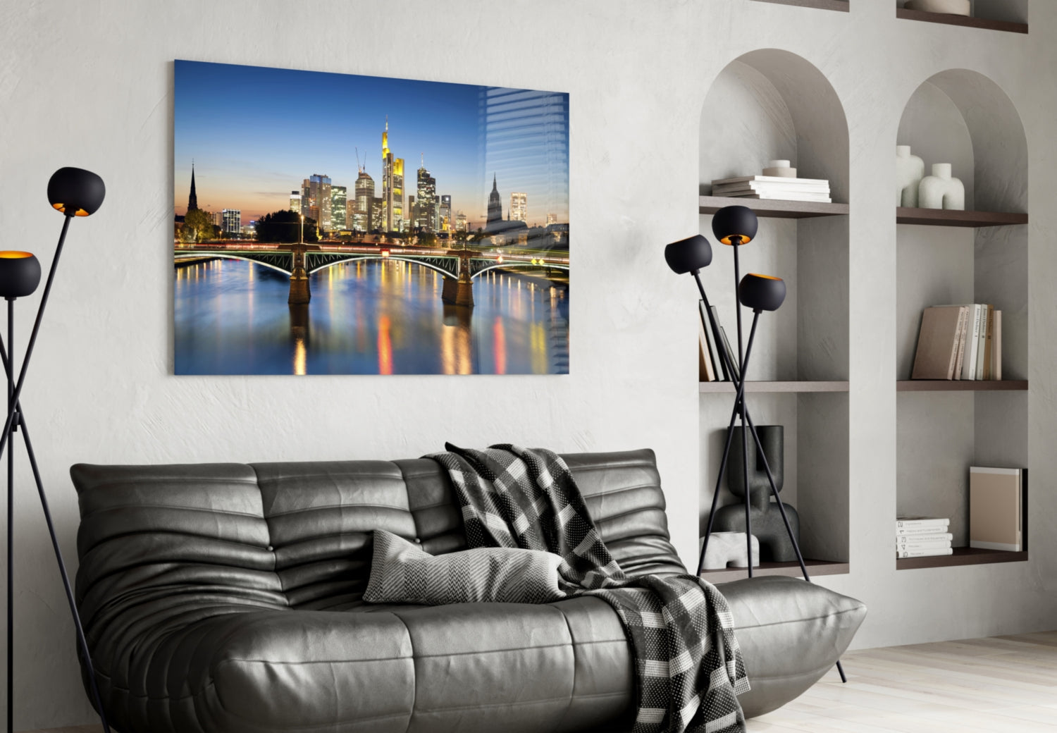 Frankfurt skyline glass wall art displayed above black leather sofa in modern living room interior.
