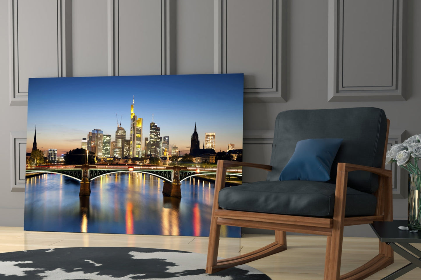 Frankfurt skyline glass wall art displayed in modern living room with wooden chair and gray paneled walls.