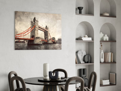 Tower Bridge glass wall art with red cables displayed above a black round dining table in a modern room with built-in shelving.