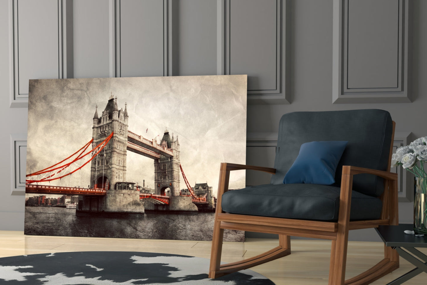 Tower Bridge glass wall art displaying sepia-toned London bridge with red cables, displayed in modern living room setting beside wooden chair.