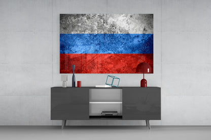 Russian flag glass wall art hanging above gray media console in minimalist interior setting.