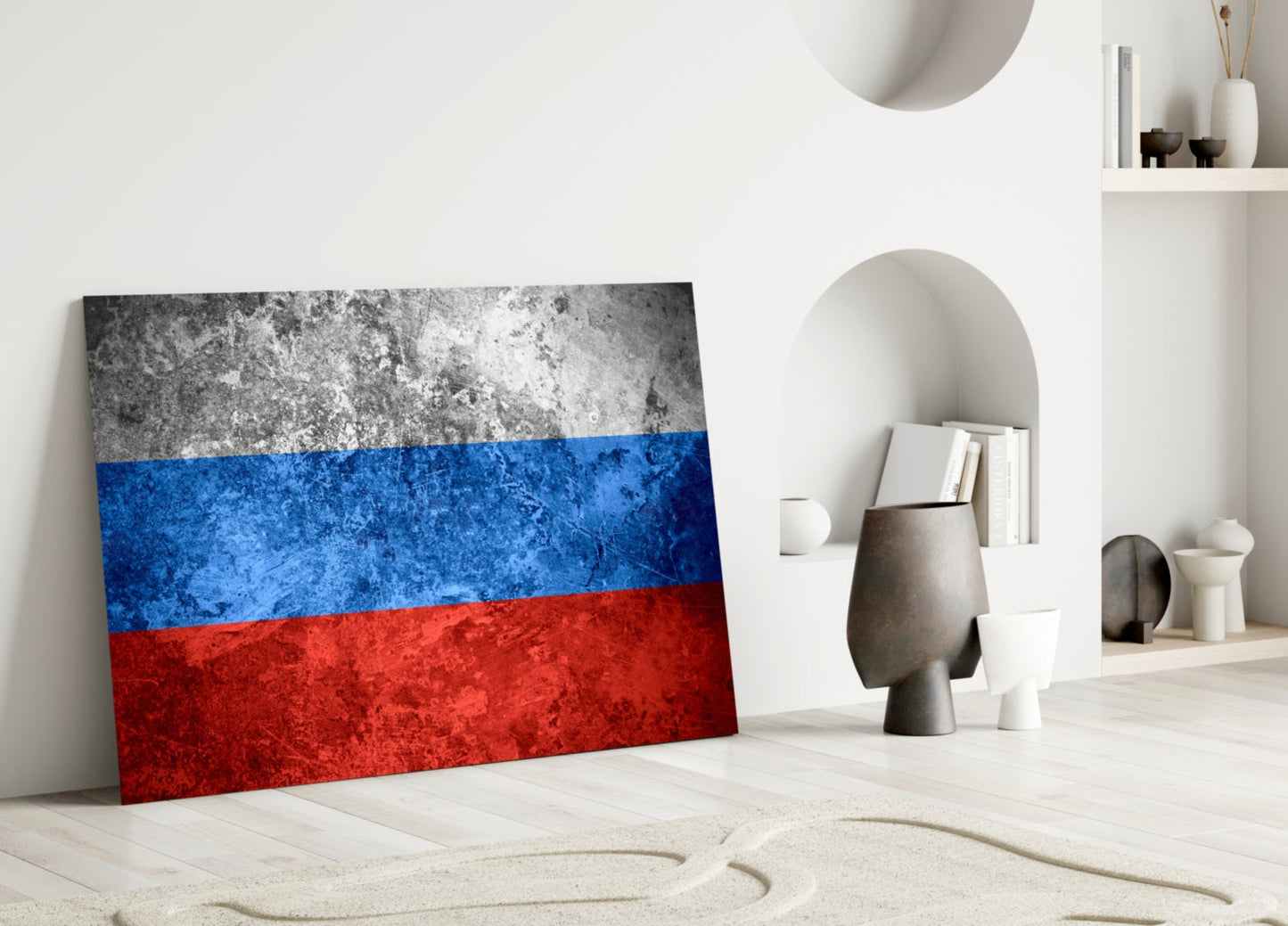Russian flag glass wall art leaning against white wall in minimalist interior setting with decorative objects and shelving.