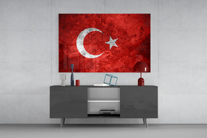 Turkish flag glass wall art with white crescent and star on red background displayed above gray media console in modern interior.