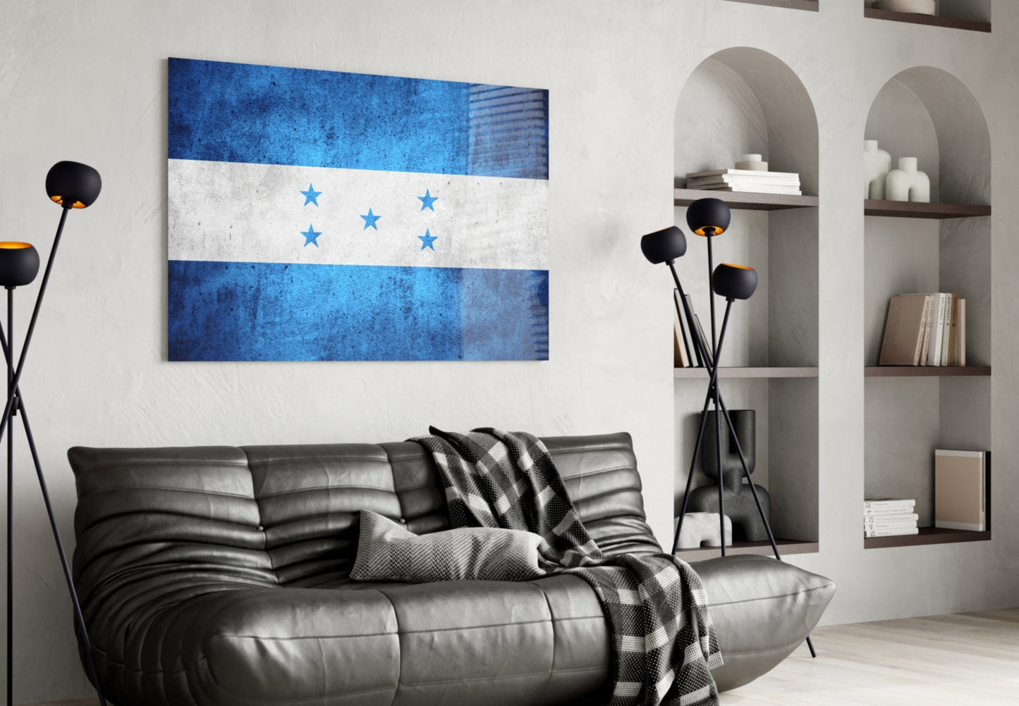 Honduran flag glass wall art displayed above black leather sofa in modern living room with shelving.