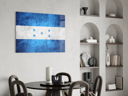 Honduran flag glass wall art displaying blue and white horizontal stripes with five blue stars, hung above a round black dining table in a modern interior.