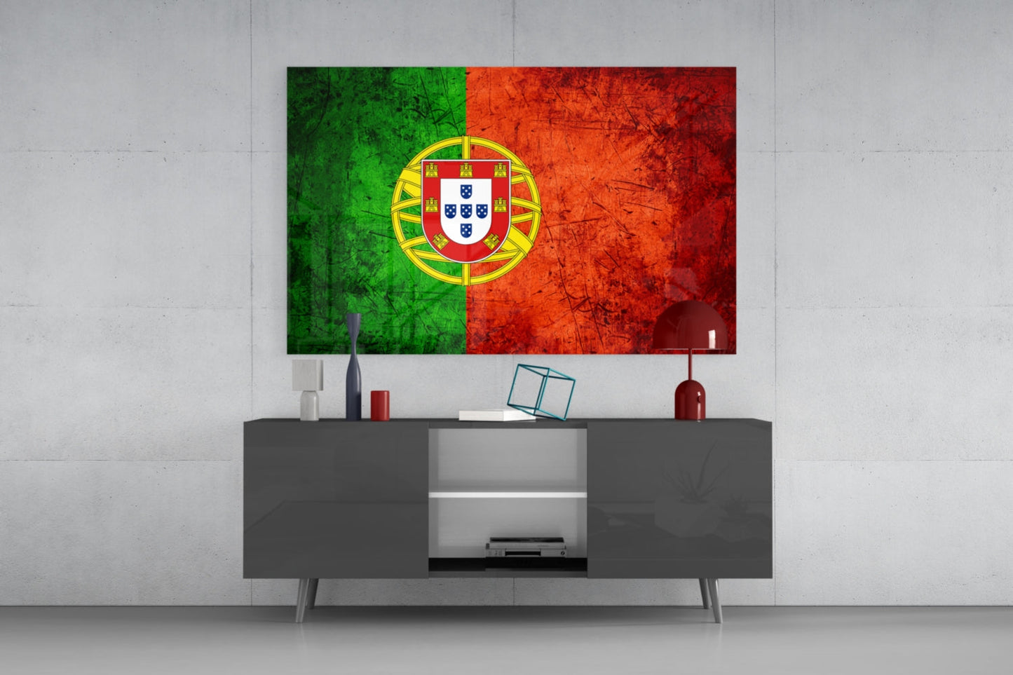 Portuguese flag glass wall art with green and red sections and yellow coat of arms displayed above gray media console in modern living room interior.
