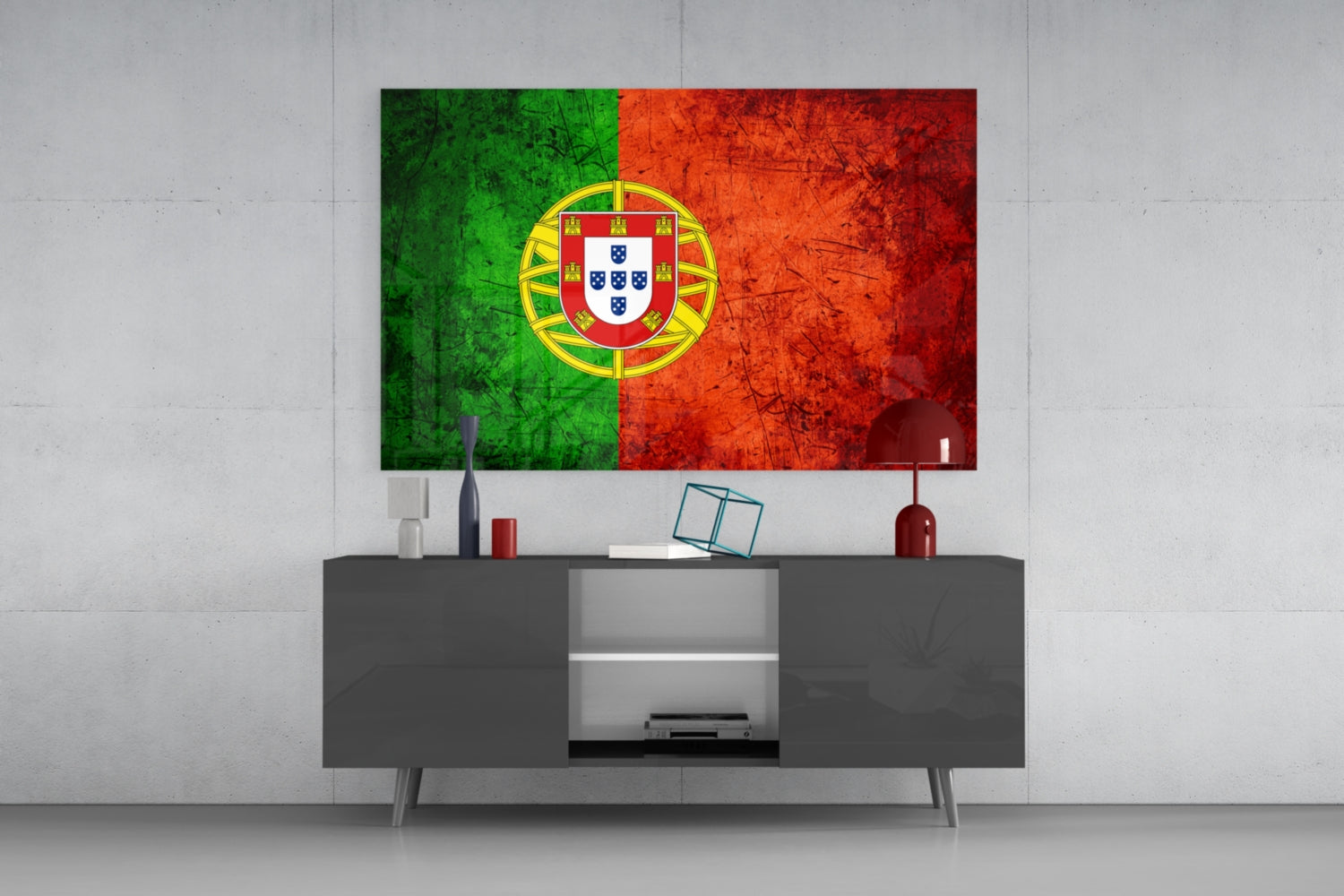 Portuguese flag glass wall art with green and red sections and yellow coat of arms displayed above gray media console in modern living room interior.