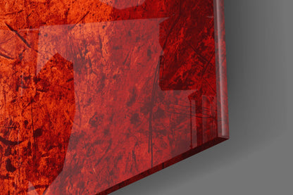 Close-up angled view of red glass wall art with textured surface and translucent layers casting shadows.