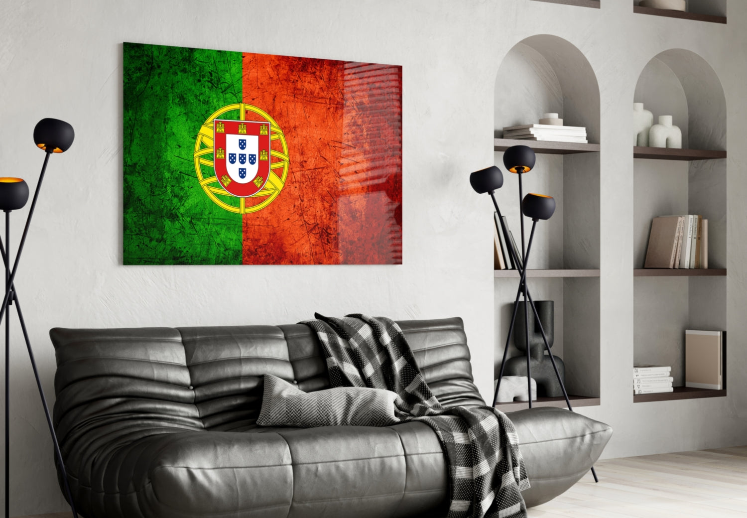 Portuguese flag glass wall art with green, red, and yellow shield displayed above black leather sofa in modern living room.