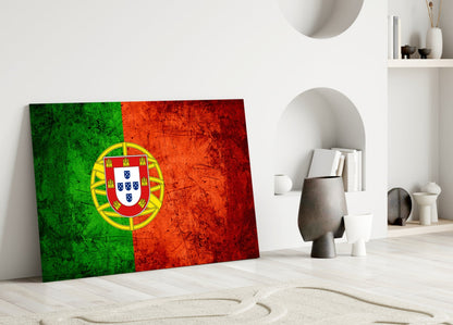 Portuguese flag glass panel leaning against white wall in minimalist interior with decorative objects and shelving.