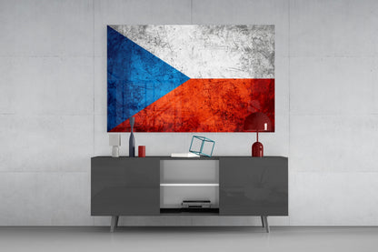 Distressed Czech flag glass wall art with blue, white, and red sections displayed above a dark gray TV console in a minimalist interior.