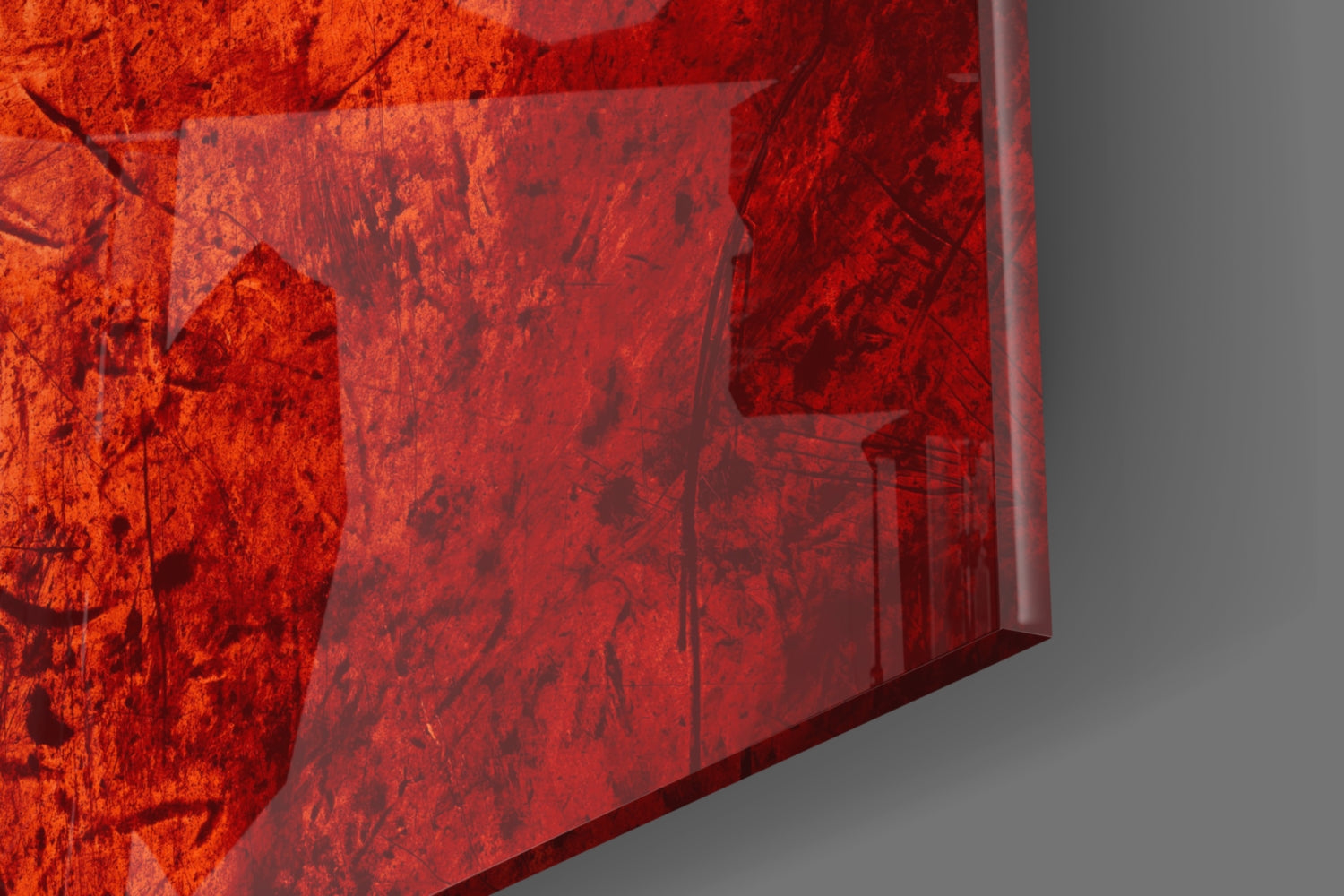 Close-up detail of red translucent glass wall art with textured surface against gray background, showing layered depth and light refraction.