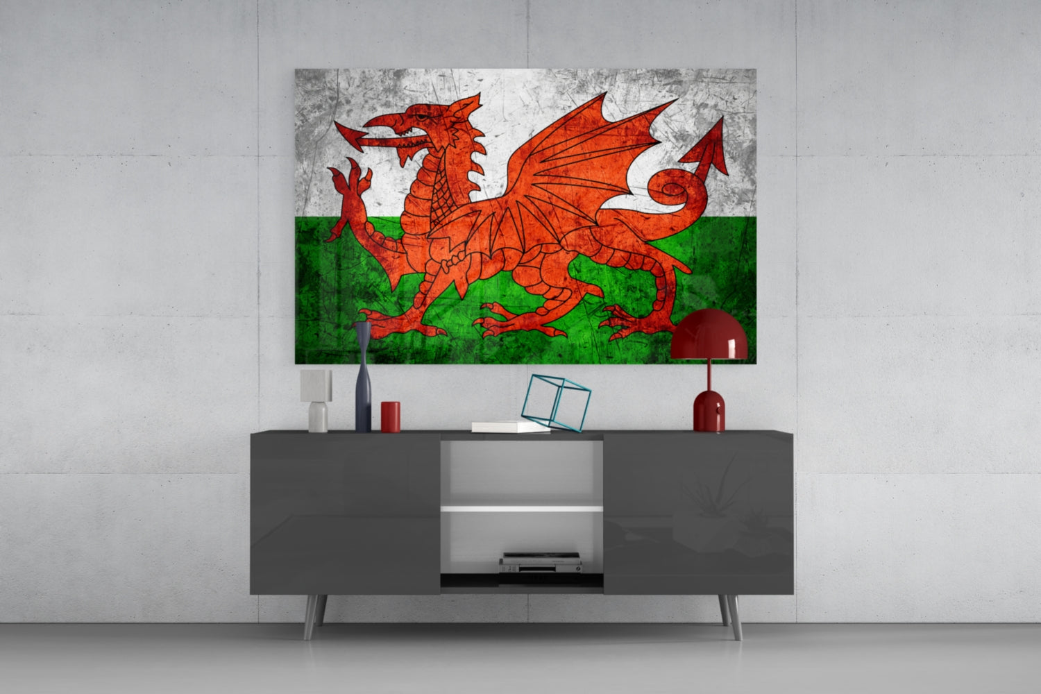 Welsh flag glass wall art displaying red dragon on green and white background, mounted above gray media console in modern interior setting.