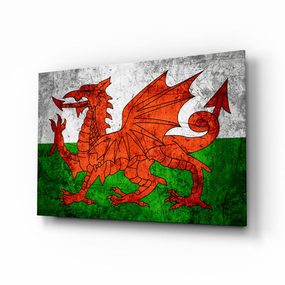 Welsh flag glass wall art displaying red dragon on white and green background, angled three-quarter view with shadow.