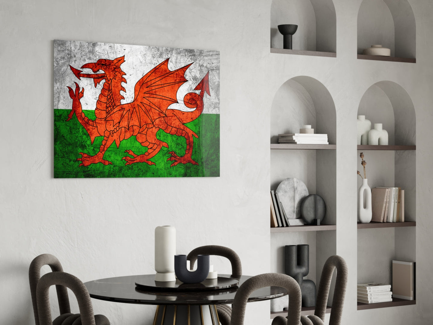 Welsh flag glass wall art depicting red dragon on white and green background, displayed above round dining table in modern interior.