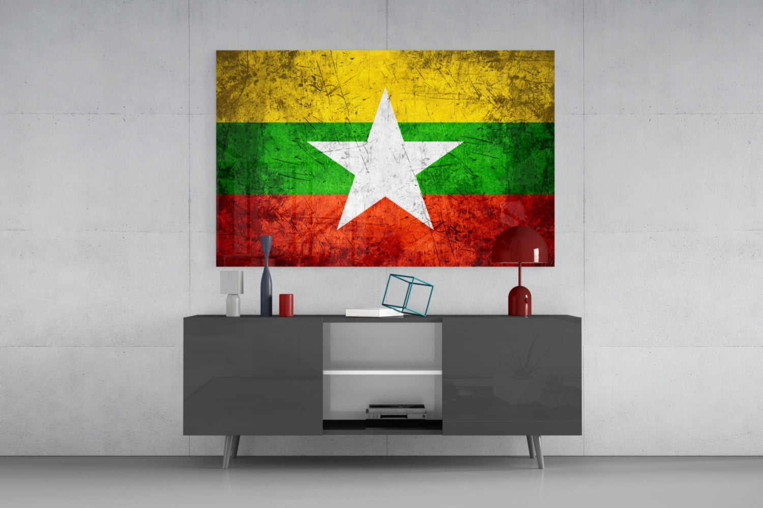 Myanmar flag glass wall art with yellow, green, and red horizontal stripes and white star displayed above gray media console.