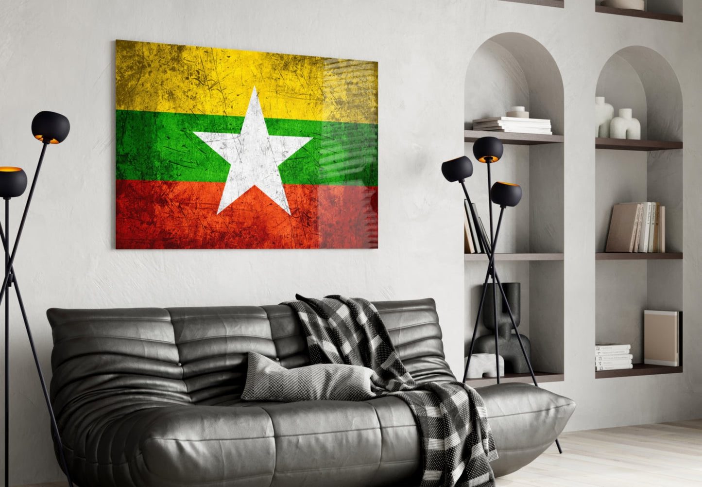 Myanmar flag glass wall art displaying yellow, green, white, and red horizontal stripes with white star, hung above black leather sofa in modern living room.