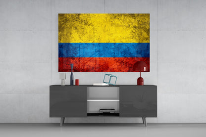 Colombian flag glass wall art with yellow, blue, and red horizontal stripes displayed above gray media console.
