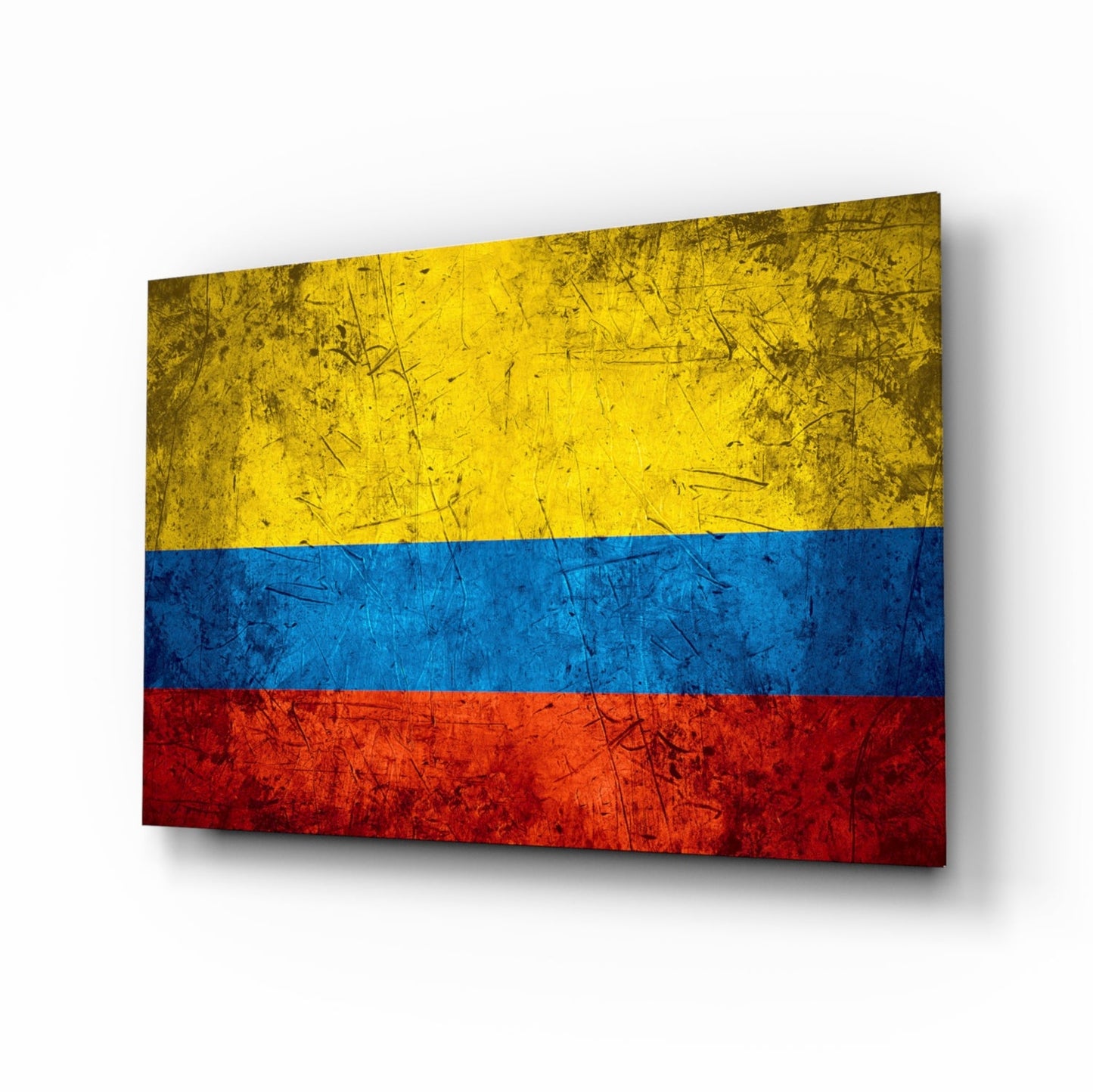 Colombian flag glass wall art displayed at an angle, showing yellow, blue, and red horizontal stripes with a distressed, scratched texture.