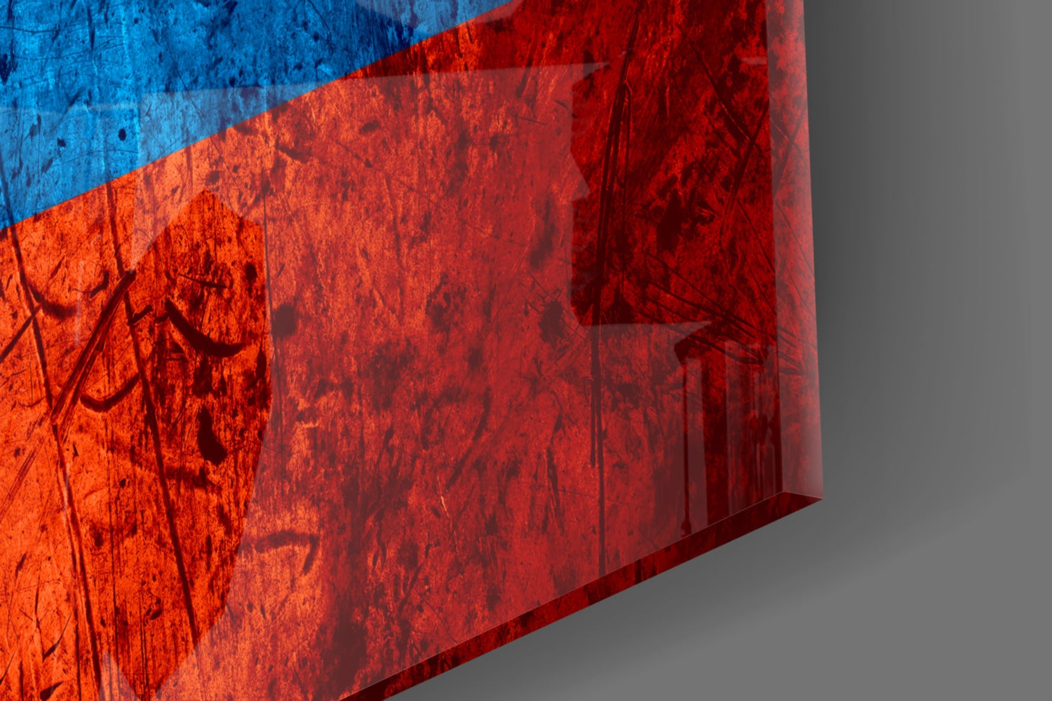 Close-up angled view of translucent glass wall art displaying Colombia's flag with blue, yellow, and red horizontal stripes showing texture and shadow details.