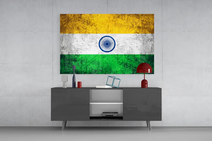 Indian flag glass wall art with saffron, white, and green horizontal stripes and blue Ashoka Chakra displayed above gray media console.