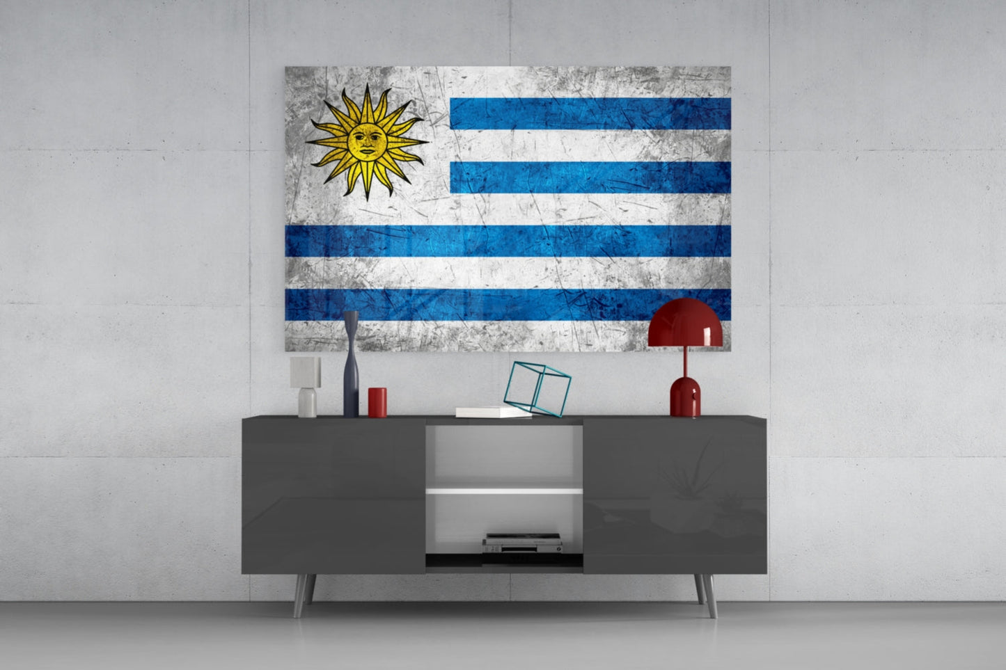 Uruguayan flag glass wall art displaying white and blue horizontal stripes with yellow sun symbol, mounted above gray media console in modern interior.