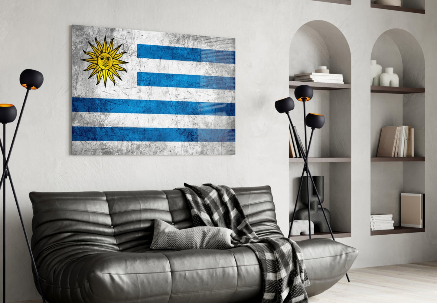 Uruguayan flag glass wall art with blue and white stripes and yellow sun displayed above black leather sofa in modern living room.
