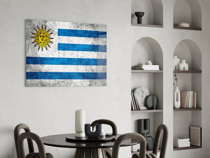 Uruguayan flag glass wall art with blue and white stripes and yellow sun displayed above a black round dining table with grey chairs.