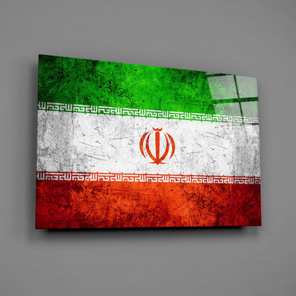Angled view of a glass wall art displaying the Iranian flag with green, white, and red horizontal stripes, red emblem, and decorative borders.