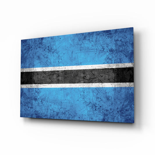 Botswana flag glass wall art displayed at an angle, showing blue, white, and black horizontal stripes with a weathered texture and shadow effect.