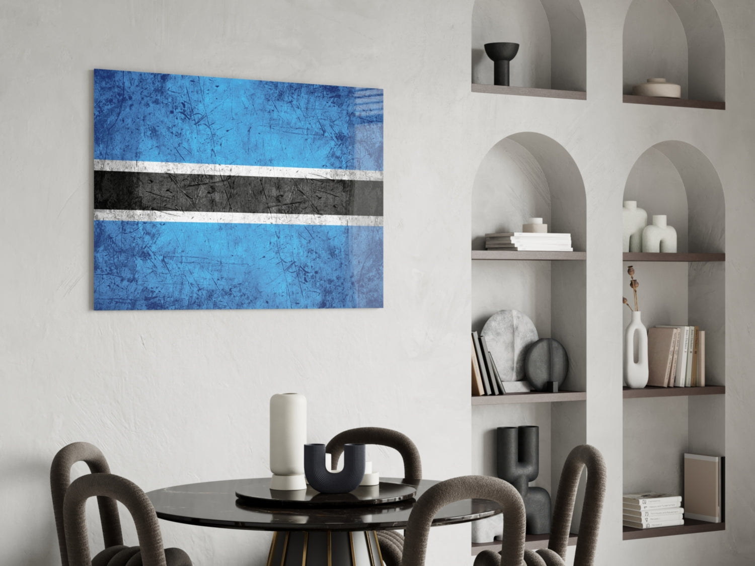 Blue, white, and black striped Botswana flag glass art displayed above black dining table in modern interior setting.
