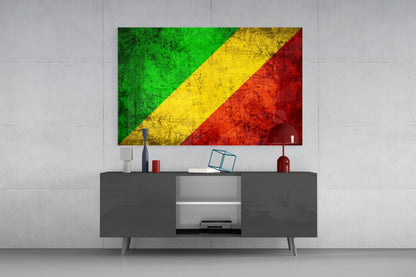 Republic of the Congo flag glass wall art displayed above a dark gray media console in a modern living room setting.