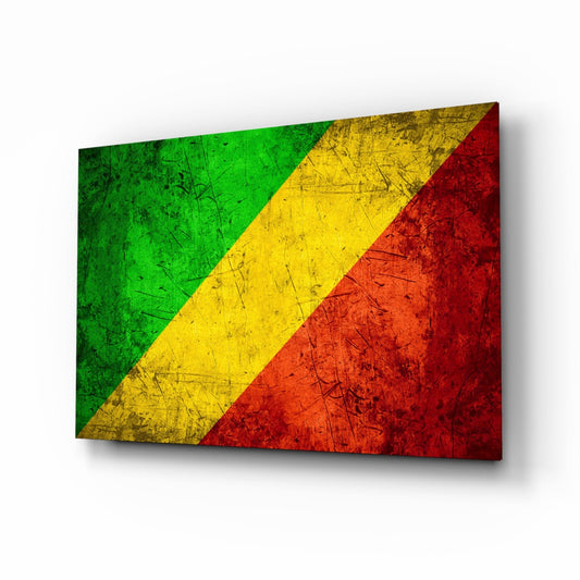 Angled view of a glass wall art panel displaying the Republic of the Congo flag with green, yellow, and red diagonal stripes, showing a weathered, distressed texture surface.