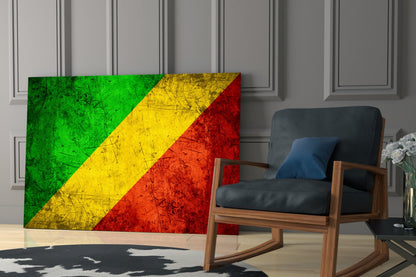 Congolese flag glass art displayed in a modern living room beside a wooden rocking chair with black leather cushioning.