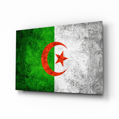 Angled perspective view of Algerian flag glass wall art displaying green and white sections with red crescent moon and star, showing textured surface and shadow.