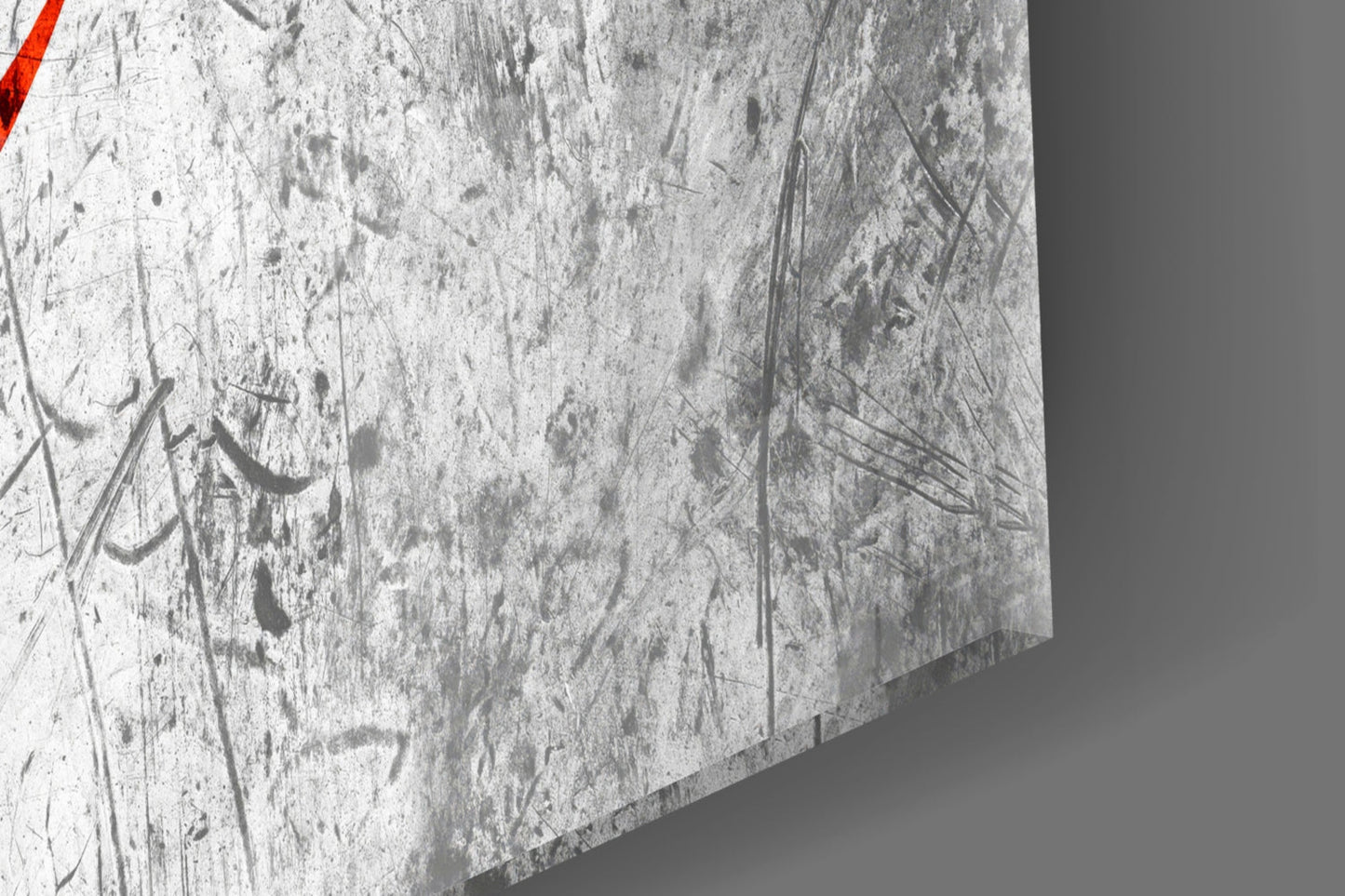 Close-up of textured glass surface with etched designs and red stripe detail in corner.