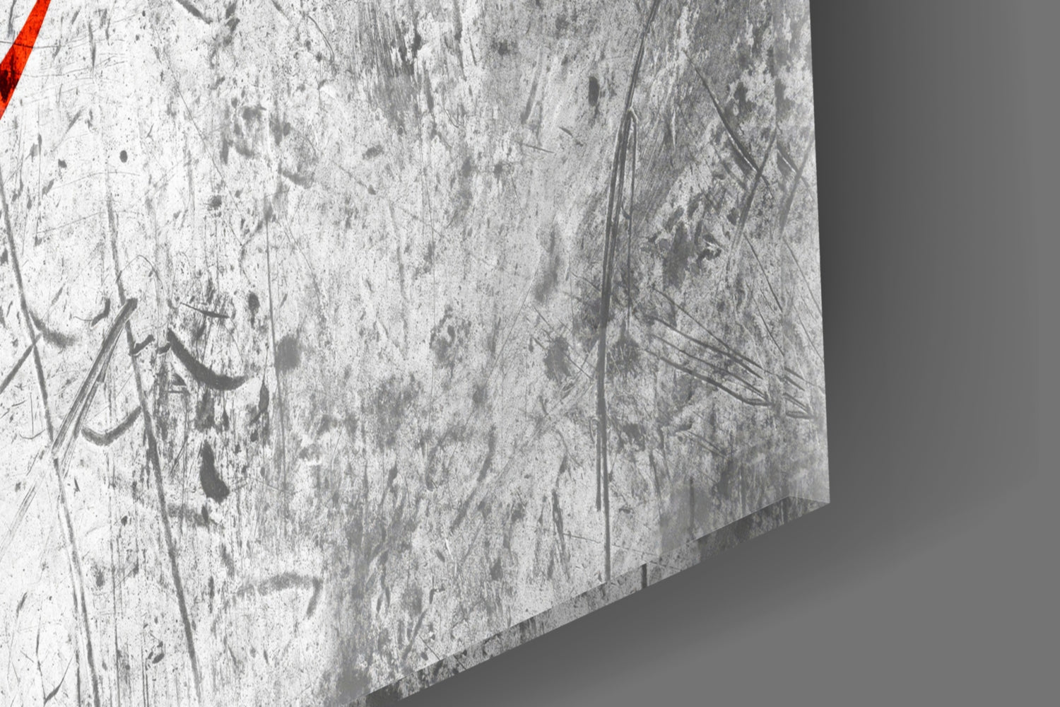 Close-up of textured glass surface with etched designs and red stripe detail in corner.