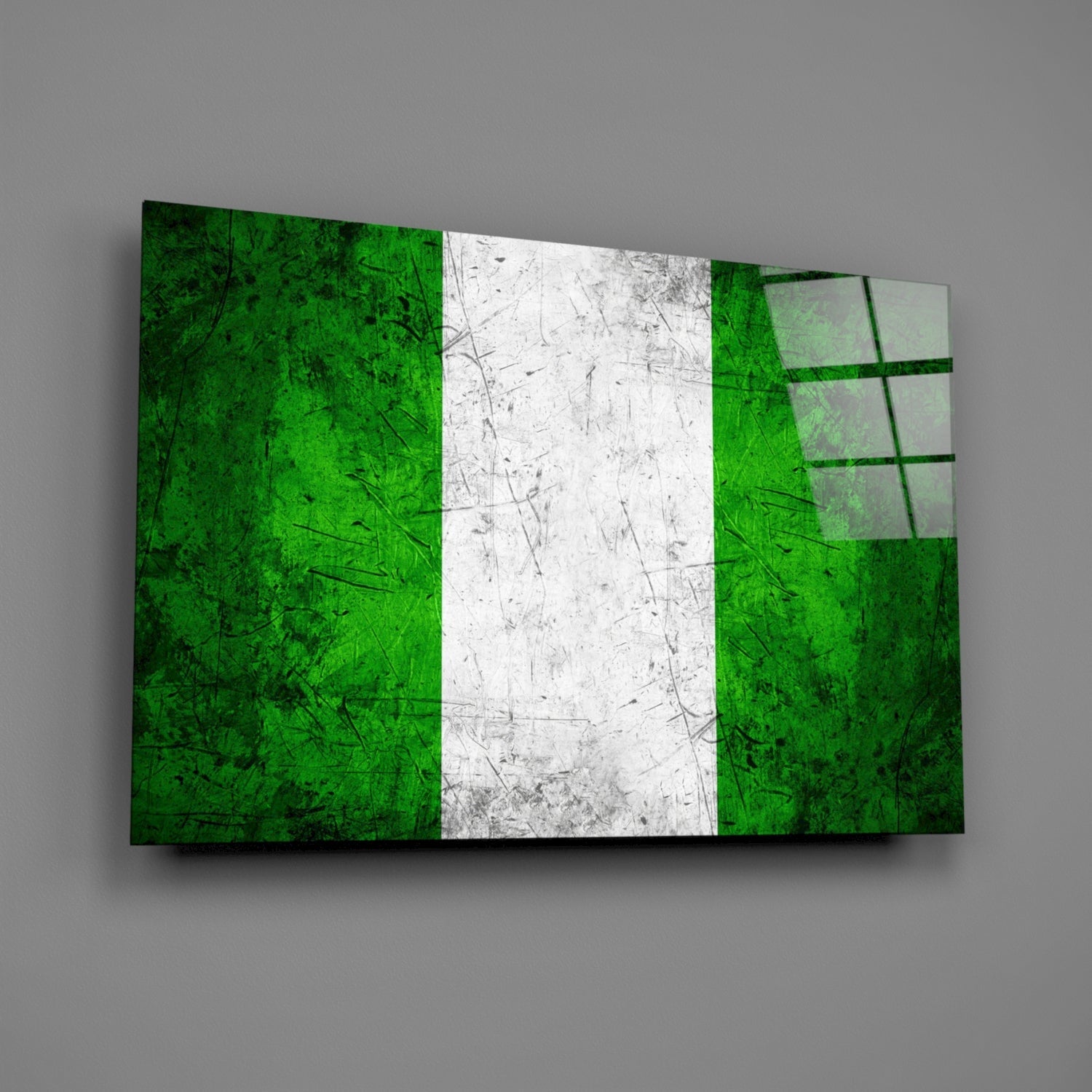 Angled view of Nigerian flag glass wall art displaying green, white, and green vertical stripes with textured surface and grid pattern on right panel.