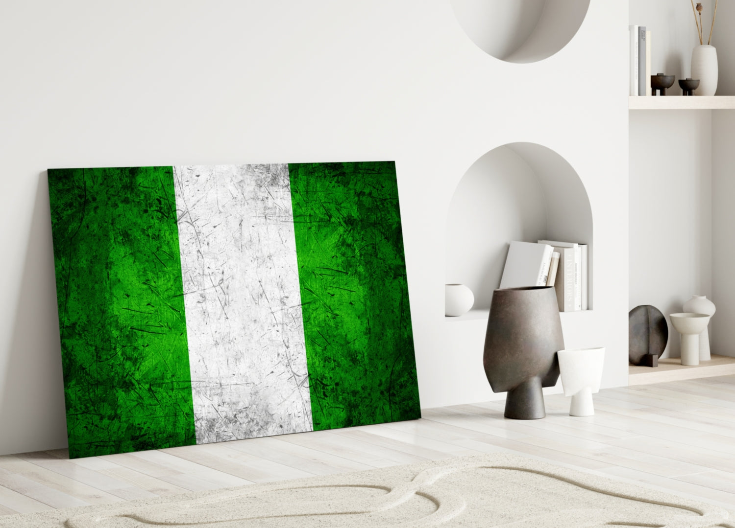 Nigerian flag glass art leaning against white wall in minimalist interior with decorative objects and shelving.
