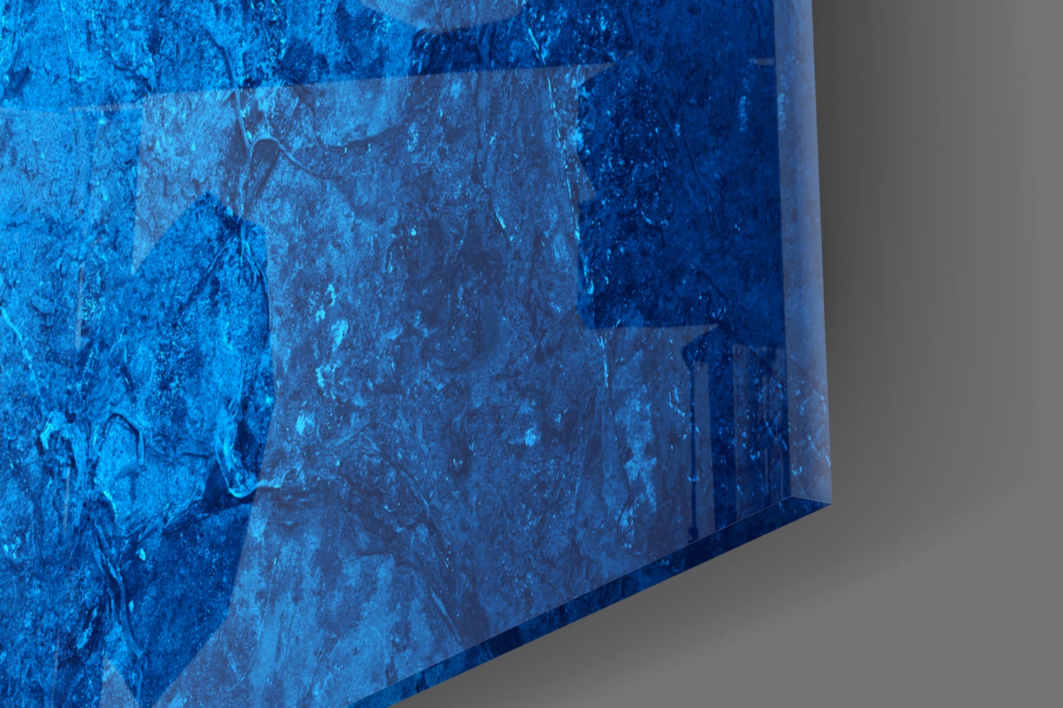 Close-up angled view of textured blue glass surface with weathered, distressed finish and visible scratches.