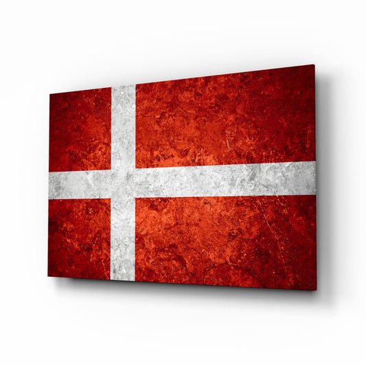 Danish flag glass wall art with mottled orange and white Nordic cross design, displayed at perspective angle with shadow.