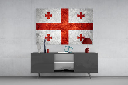 Flag of Georgia glass wall art displaying red crosses on white background, mounted above gray media console in modern interior setting.
