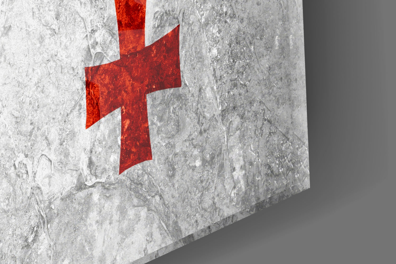 Red Georgian cross on textured gray concrete surface, angled perspective view of glass wall art.