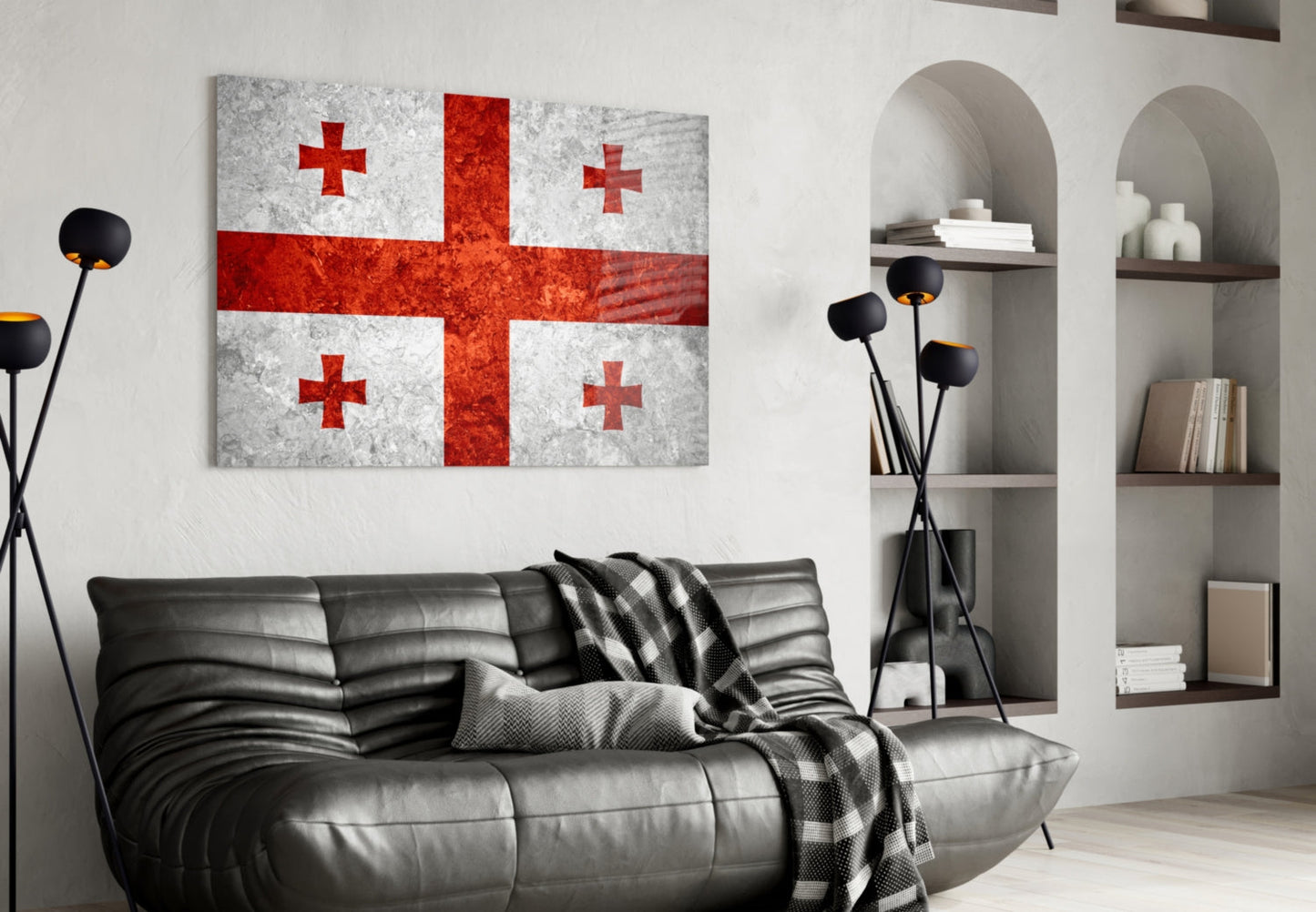 Georgian flag glass wall art with red crosses on white background displayed above black leather sofa in modern living room interior.